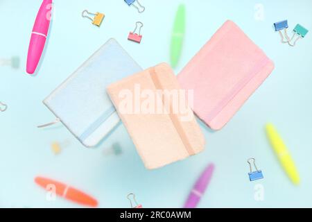 Notebooks with stationery on blue background Stock Photo