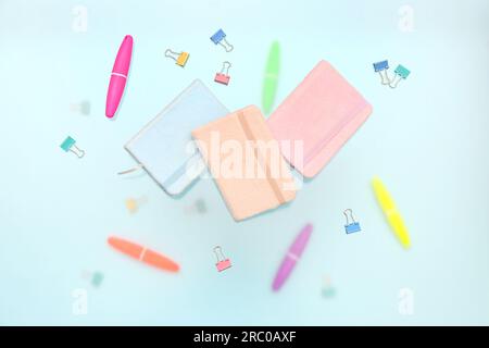 Notebooks with stationery on blue background Stock Photo