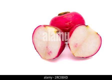 Whole and half radish on a white background in close-up Stock Photo