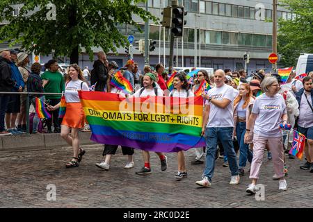 Diplomats for LGBT+ rights with a rainbow banner at Helsinki Pride 2023 parade in Helsinki, Finland Stock Photo