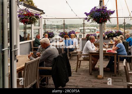 Hugh Town, St Marys, Scilly Isles, UK. 10 June 2023. Customers drinking and eating in a waterfront restaurant in Hugh Town on St Marys Island, Scillie Stock Photo