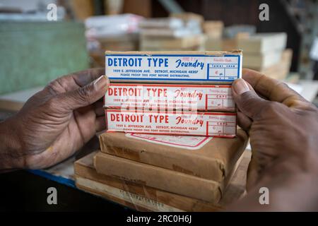 Detroit, Michigan - At his letterpress print shop, Amos Kennedy holds unopened containers of Franklin Gothic type from the old Detroit Type Foundry. Stock Photo
