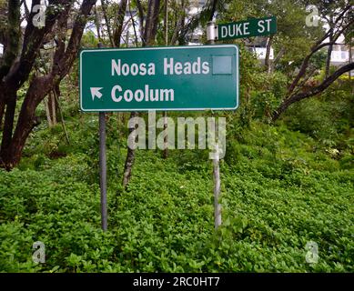 Road sign in Sunshine Beach on Queensland's Sunshine Coast shows the direction to Noosa Heads and to Coolum Beach, and also small sign for Duke Street Stock Photo