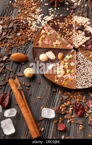 Creative composition chocolate in the shape of a pizza with candied fruits, nuts, dry berries, chocolate pizza and ingredients Stock Photo