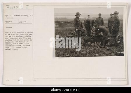 Sergeant 1st Class Morris Fineberg is seen in this photo from March 12, 1919. The image shows shells being stacked on the ground to be blown up. There are two 210 mm high explosive shells and the rest are 77 mm gas shells. This work is being carried out by the Reclamation and Demolition office of the Battle Area, Field Ammunition Office, Ordnance Department, 1st Army in Stenay, Meuse, France. Stock Photo