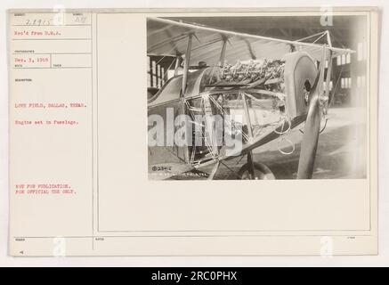 American military personnel working on an engine set within the fuselage at Love Field in Dallas, Texas. This photograph depicts an activity related to aircraft maintenance during World War One. This image is not meant for public use and is solely for official purposes. Stock Photo