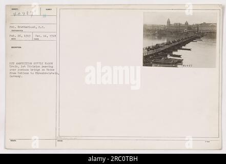 The 1st Ammunition Supply Wagon train from the 1st Division is seen crossing a pontoon bridge on the Rhine from Coblens to Ehrenbreitstein in Germany. This photograph was taken on February 26, 1919, by Pvt. Brotherhood, S.C. It is image number 40987 of the series. Note: This description was recorded on December 14, 1918. Stock Photo