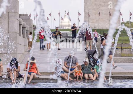 Washington, USA. 11th July, 2023. People cool off by a fountain in Washington, DC, the United States, on July 11, 2023. Credit: Aaron Schwartz/Xinhua/Alamy Live News Stock Photo