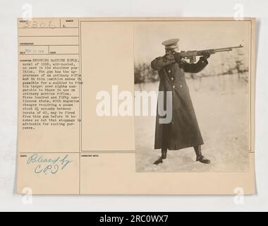 American soldier is seen holding a Browning Machine Rifle, model of 1918, air-cooled, in a shoulder position during World War One. The gun resembles an ordinary rifle and allows the soldier to aim using sights similar to those found on service rifles. It is capable of firing 350 continuous shots, with short pauses for magazine changes, before requiring cooling. Photograph taken on February 25, 1918. Stock Photo