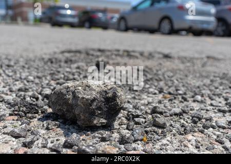 Small rock on road - rough texture close up background. Taken in Toronto, Canada. Stock Photo