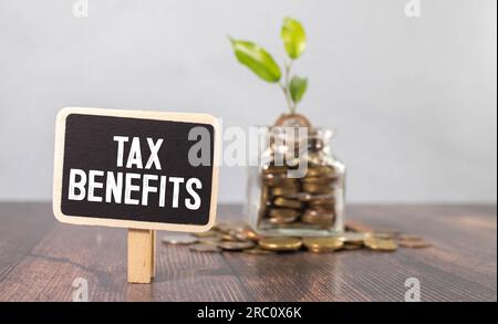 On a white tablet the inscription TAX BENEFITS on the background of accounting Stock Photo