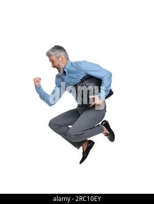 Mature businessman in stylish clothes with briefcase jumping on white background Stock Photo