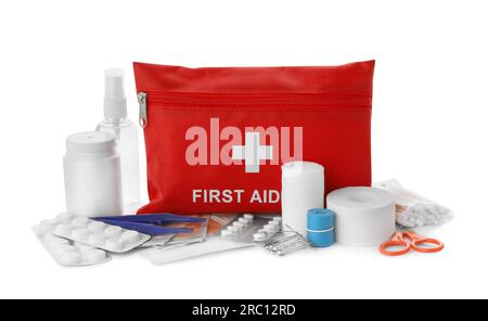 Red first aid kit, scissors, pins, cotton buds, pills, plastic forceps, medical plasters, hand sanitizer and elastic bandage isolated on white Stock Photo