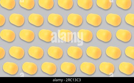 Mykolaiv, Ukraine - June 26, 2023: Yellow plastic capsule from Kinder Surprise Egg on grey background, seamless pattern design Stock Photo