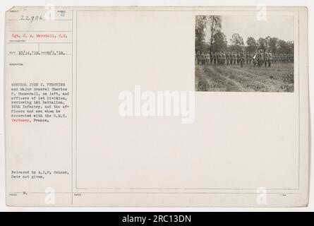 General John J. Pershing and Major General Charles P. Summerall, along with officers of the 1st Division, are seen reviewing the 1st Battalion, 16th Infantry in Vertusey, France. General Pershing can be seen decorating officers and men with the Distinguished Service Cross. The exact date of the photograph is unknown. Stock Photo