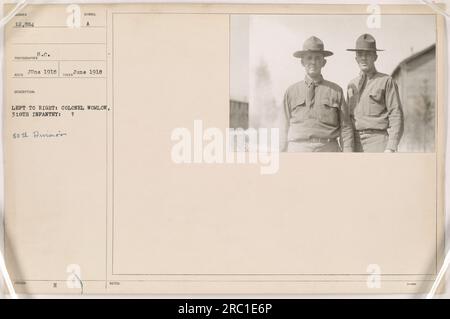 Colonel Womlow of the 318th Infantry, pictured on the left, stands with an unidentified soldier from the 80th Division. Photograph taken in June 1918. This image was received and issued with the symbol AUMBER 12,884 in June 1918. No additional notes were provided. Stock Photo