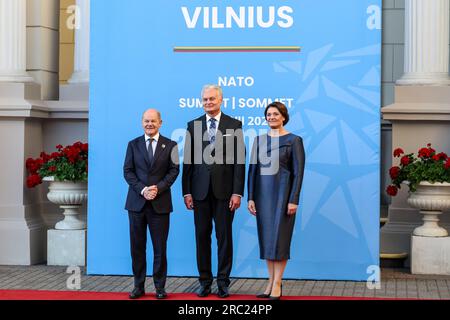 Vilnius, Lithuania. 11th July, 2023. President of Lithuania, Gitanas Naus?da and his wife Diana Naus?dien? welcome the Chancellor of Germany, Olaf Scholz as he arrives for a social dinner during the high level NATO summit. The President of Lithuania hosts the dinner for world leaders at the Presidential Palace. The summit agenda covers Ukraine's bid to join the organisation, the accession process of Sweden, boosting arms stockpiles and reviewing plans. Credit: SOPA Images Limited/Alamy Live News Stock Photo