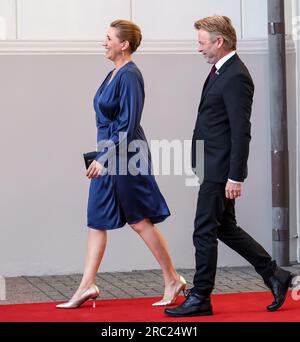 Vilnius, Lithuania. 11th July, 2023. The Prime Minister of Denmark, Mette Frederiksen and her husband, Bo Tengberg arrive for a social dinner during the high level NATO summit. The President of Lithuania hosts the dinner for world leaders at the Presidential Palace. The summit agenda covers Ukraine's bid to join the organisation, the accession process of Sweden, boosting arms stockpiles and reviewing plans. Credit: SOPA Images Limited/Alamy Live News Stock Photo