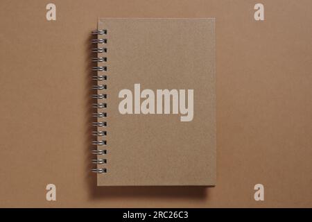 Brown notebook with spiral close-up, top view Stock Photo