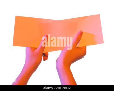 Man holding flyers on white background, closeup and space for text. Color tone effect Stock Photo