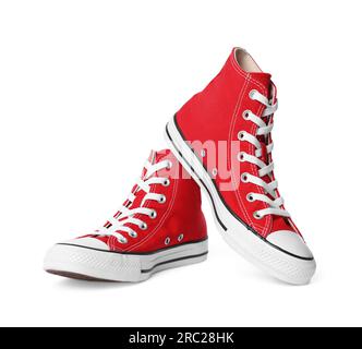 Pair of new red stylish high top plimsolls on white background Stock Photo