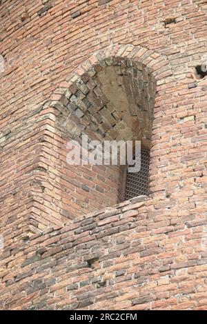 Fragments of the old fortress. From red brick. Fortress loopholes. Stock Photo