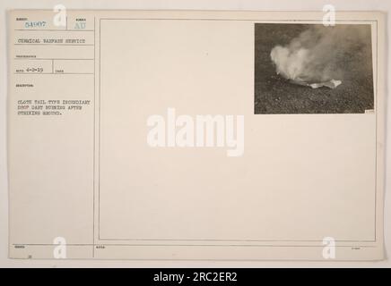 Cloth tail type incendiary drop dart burning on the ground after impact. This photograph was taken on April 2, 1919, by photographer RTED. The subject number is AU Chemical Warfar Service 54907. It is described as a cloth tail type incendiary drop dart. Additional notes mention it was issued on February 2, 1911. Stock Photo