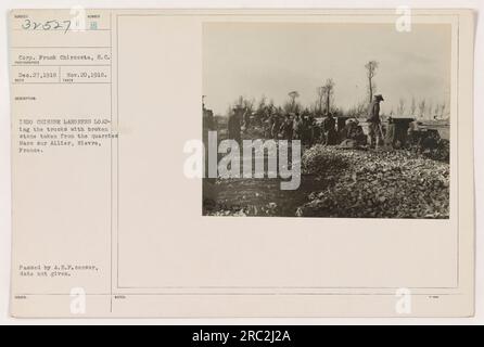 'Indo-Chinese laborers loading trucks with broken stone from quarries in Mars sur Allier, Nievre, France. Photograph taken by Corp. Frank Chircosta, S.C. on Nov. 20, 1918. The image shows a group of laborers working at the rock quarries during World War One. Censored by A.E.F., date not provided.' Stock Photo