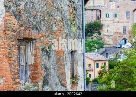Old weathered window on a brick wall Stock Photo