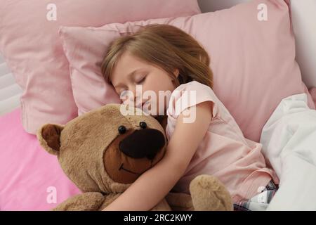 Little girl snoring while sleeping in bed Stock Photo