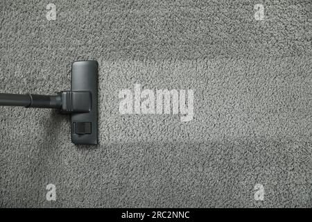 Vacuuming grey carpet. Clean area after using device, top view. Space for text Stock Photo