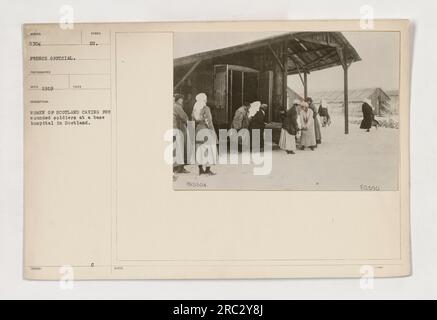 This image depicts women from Scotland attending to wounded soldiers at a Scottish base hospital during World War One. It was taken by a French photographer in 1919 and is identified as image 111-SC-5304 in the collection of American Military Activities during the war. Stock Photo