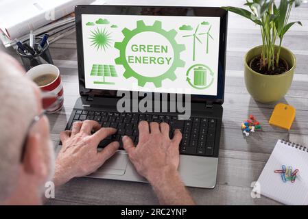 Green energy concept shown on a laptop used by a man Stock Photo