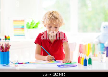 Kids paint. Child painting in white sunny study room. Little boy drawing  rainbow. School kid doing art homework. Arts and crafts for kids Stock  Photo - Alamy