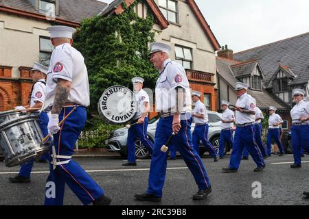 Lurgan, County Armagh, Northern Ireland.12 Jul 2023. The Twelfth of July is marked by Orange Order parades across Northern Ireland. Lurgan District left their headquarters at Brownlow House before parading up the town to the war memorial ahead of the main County Armagh demonstration being held in the town this year.The parades across Northern Ireland mark the victory of William of Orange over James at the Battle of the Boyne in 1690. Credit: CAZIMB/Alamy Live News. Stock Photo