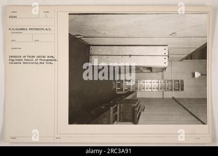 Interior view of the print drying room at the Signal Corps School of Photography, located in Columbia University, New York. The image is numbered 46544 S.C. Columbia University and was taken as part of the photographer's description. This photograph provides a detailed view of the drying process for photographic prints within the school. Stock Photo
