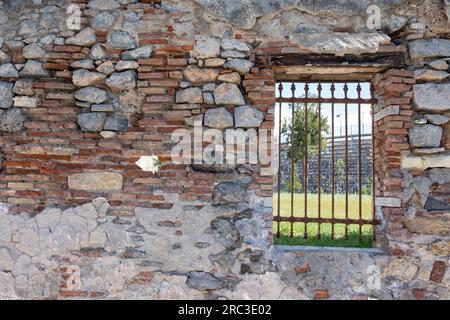 Elefsina, Attica Greece. 2023 European Capital of Culture. View through rusty window grid of Open Air Theater at old Olive Mill Factory. Stock Photo