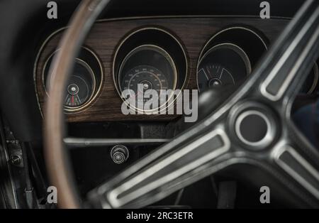 Classic Car Vintage Dashboard and Steering Wheel. Automotive History Theme. Stock Photo