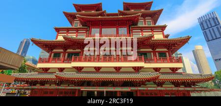 Buddha Tooth Relic Temple in Singapore's Chinatown district captivates with its architectural splendor. Business district skyline reflects a Stock Photo