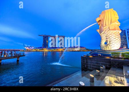 Singapore - April 27, 2018: icon of Singapore Merlion Statue with a lion's head and body of a fish spouting water from the mouth and three towers of Stock Photo