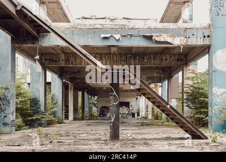 Bangkok, Thailand - Jul 08, 2023 - Beside the old metal staircase is in the abandoned buildings and was left to deteriorate over years. It was ruined Stock Photo