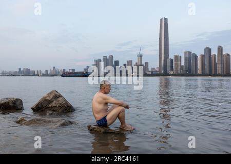 Wuhan, China. 11th July, 2023. A man cools off in the Yangtze River in Wuhan. July 11 marks the beginning of what is traditionally known as China's 40-day hot and humid season, the dog days of summer, on Tuesday, the National Meteorological Center extended an orange alert - the second-highest alert - for high temperatures, as heat waves scorch vast swathes of the country. (Photo by RenYong/SOPA Images/Sipa USA) Credit: Sipa USA/Alamy Live News Stock Photo