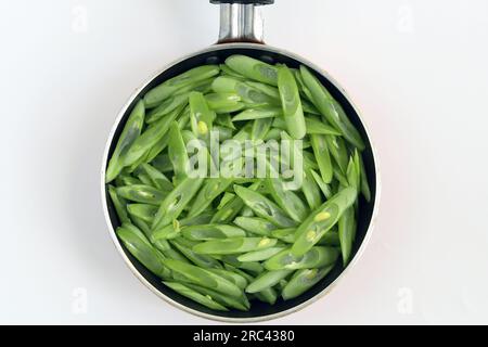 Raw green beans on frying pan isolated on white background Stock Photo