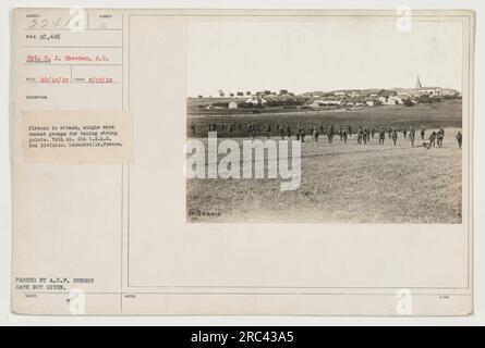 Caption: 'Image #22414: Corporal D. J. Sheehan from the Signal Corps photographing the 76th Company, 6th U.S. Marine Corps, 2nd Division during an attack on Harmonville, France on August 23, 1918. The platoon is seen advancing in single file, with combat groups taking strong points. Photograph taken by Photographer Reed and approved by A.E.P. censor. © National Archives' Stock Photo