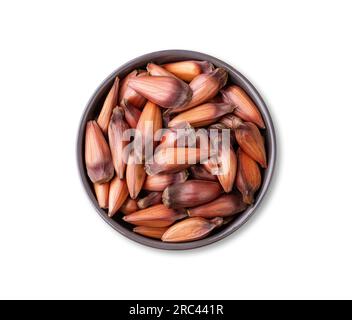 Pinions or pine tree seeds on a bowl isolated over white background. Stock Photo