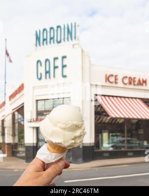 hand holding Nardinis ice cream cone outside Nardini Cafe and ice cream parlour, Largs, Scotland, UK Stock Photo