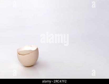 Broken or cracked egg shell isolated on white background. Stock Photo