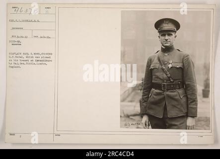 Chaplain Earl H. Weed displaying his Distinguished Service Medal, which was awarded to him and pinned on his chest by Major General Biddle during an investiture ceremony in London, England. This photo was taken on January 9, 1919, by photographer S.C. Donnelly. Image number is H463731. Stock Photo