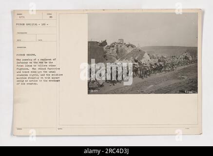 A regiment of infantry passing through a war-ravaged area on their way to the front lines. The soldiers march resolutely, seemingly unperturbed by the destruction around them. This photograph, taken by a French official photographer, showcases the stark reality of war and the determination of the troops. Stock Photo