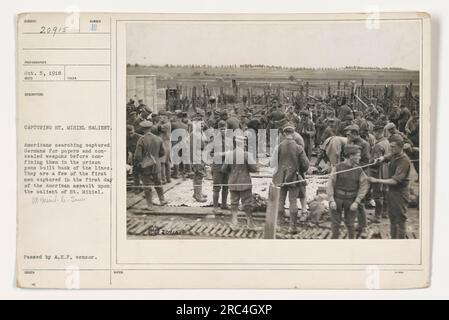 American soldiers search captured German soldiers for papers and concealed weapons before confining them in prison pens. These Germans were some of the first captured during the American assault on the St. Mihiel salient. Photo taken on October 5, 1918. Image number: 20915. Stock Photo